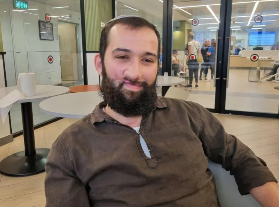 A man with a beard and a scar on his lips down to his cheek