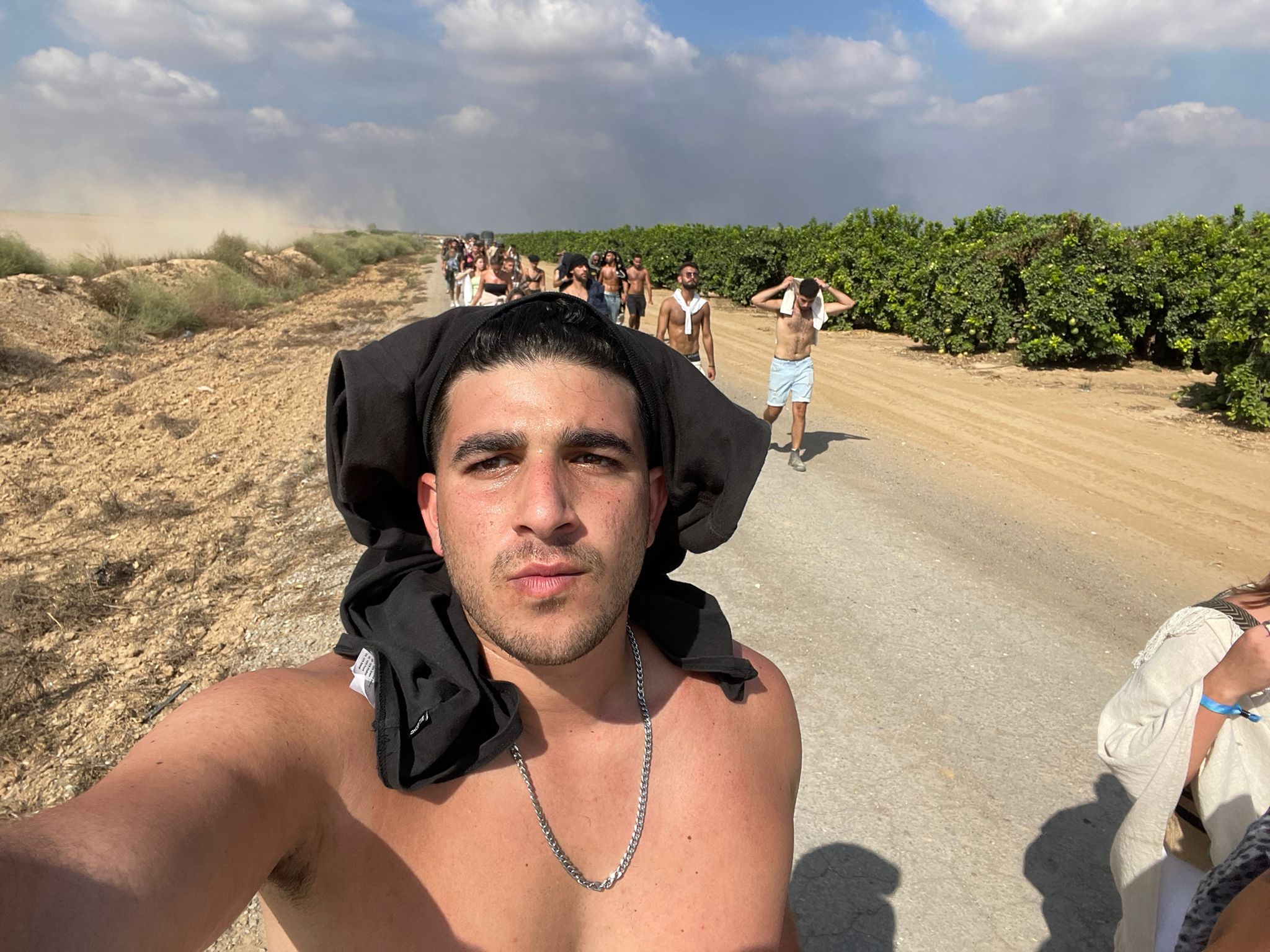 Adir walking with other party goers