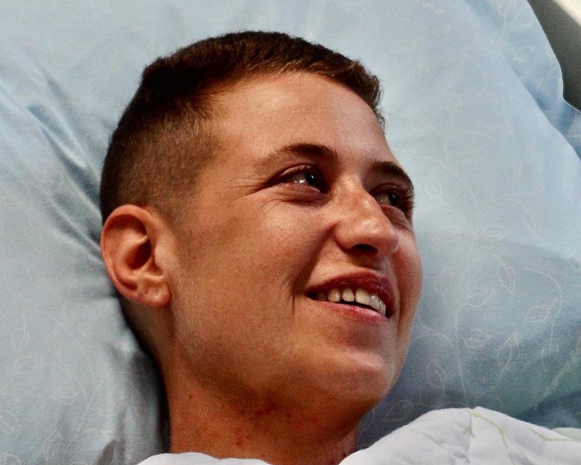 close up of Naama smiling on her hospital bed