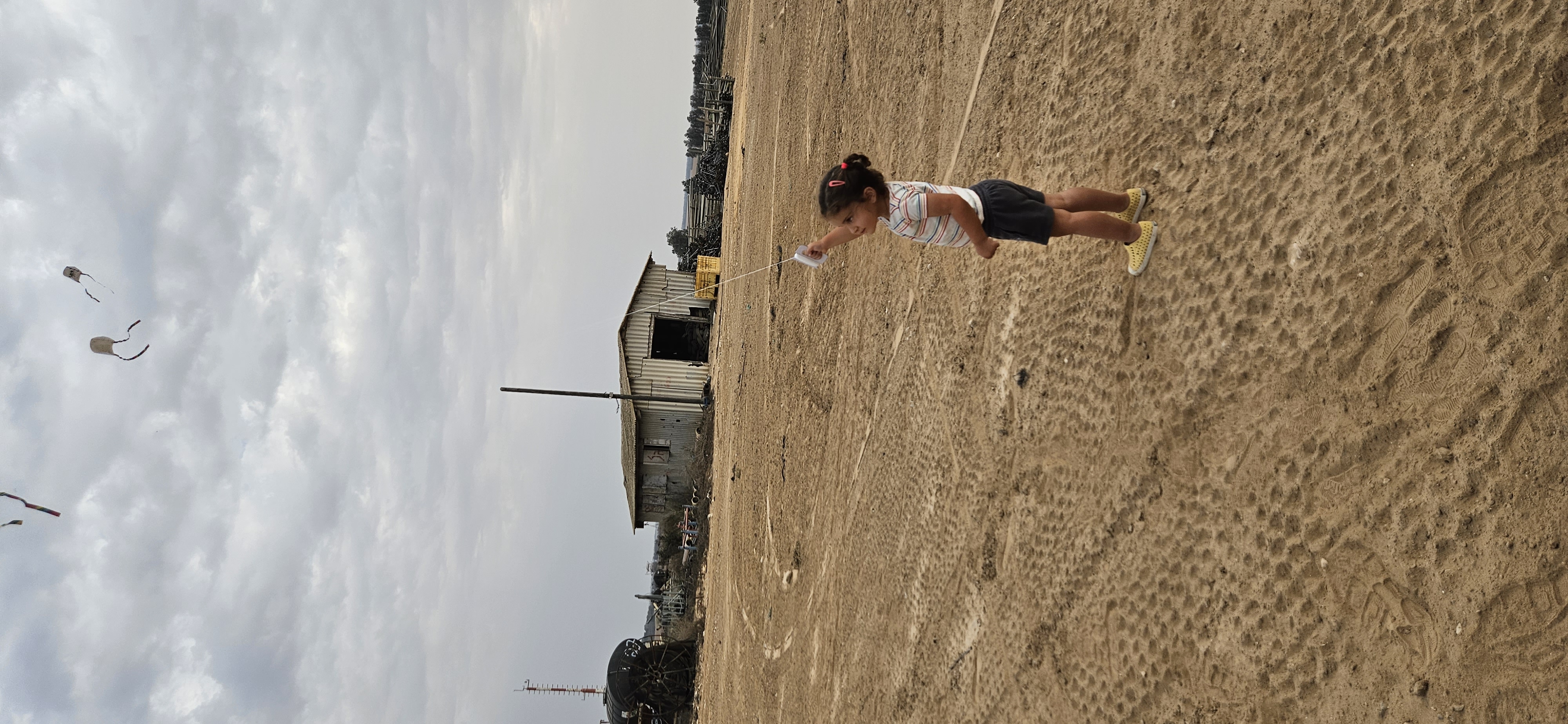 A girl is flying a kite