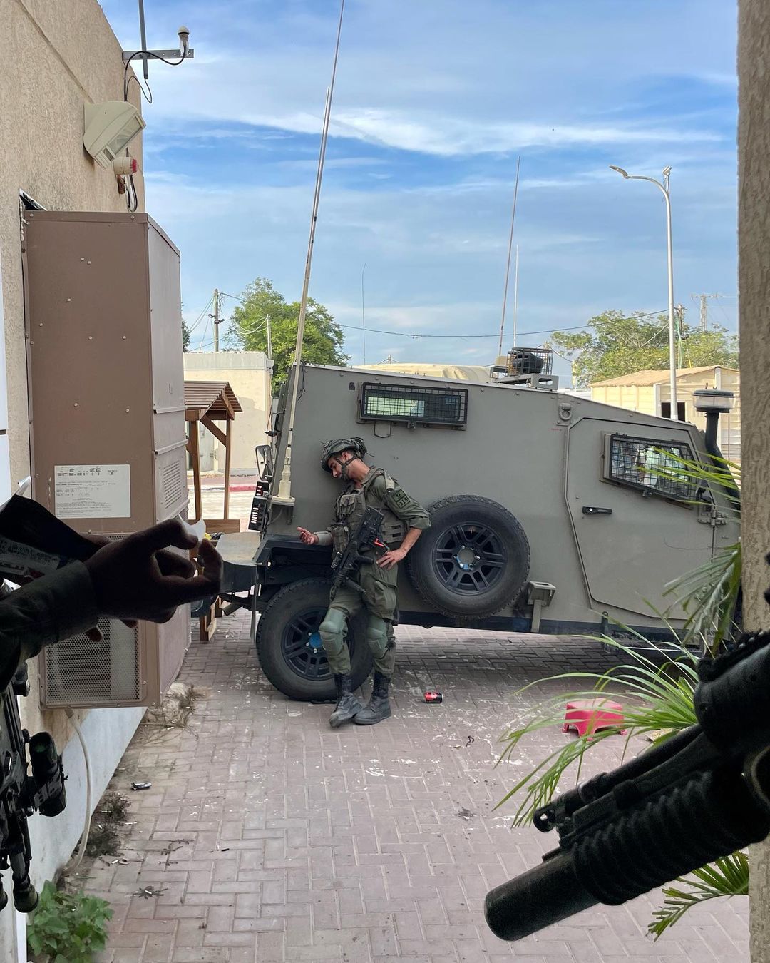 A soldier stands next to a military vehicle