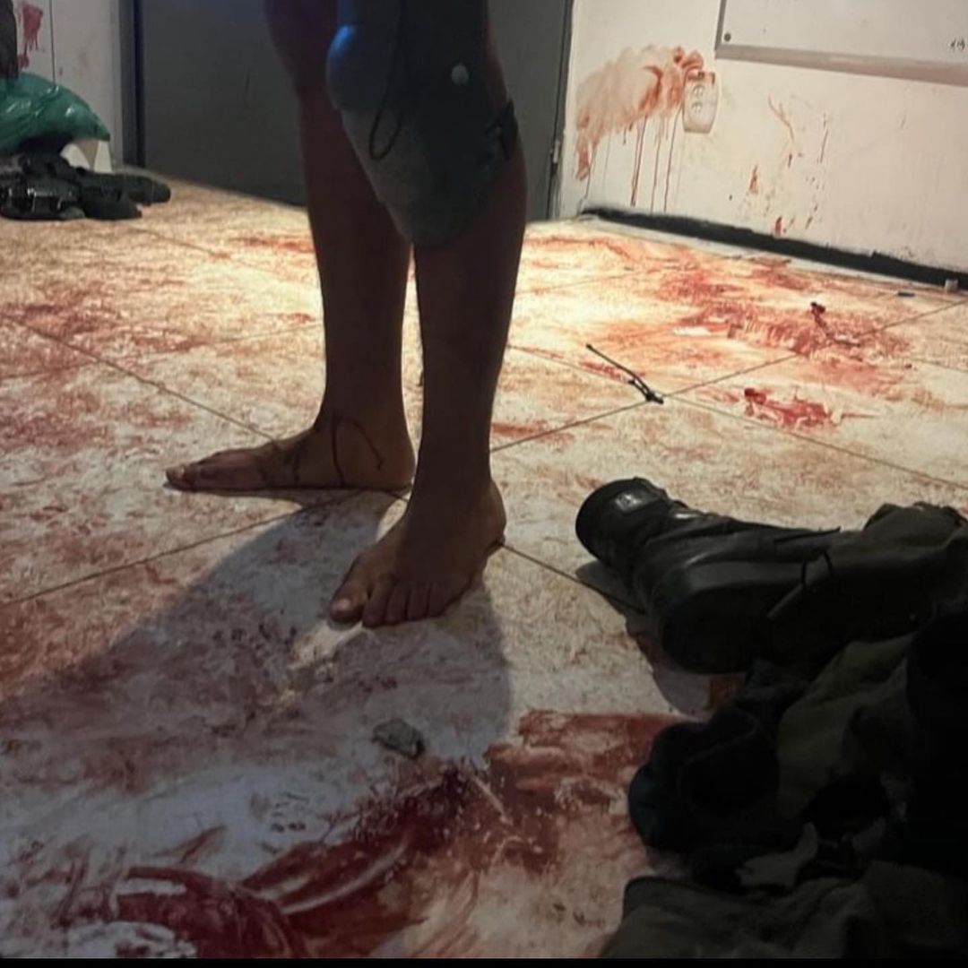 A soldier stands on a floor covered in blood