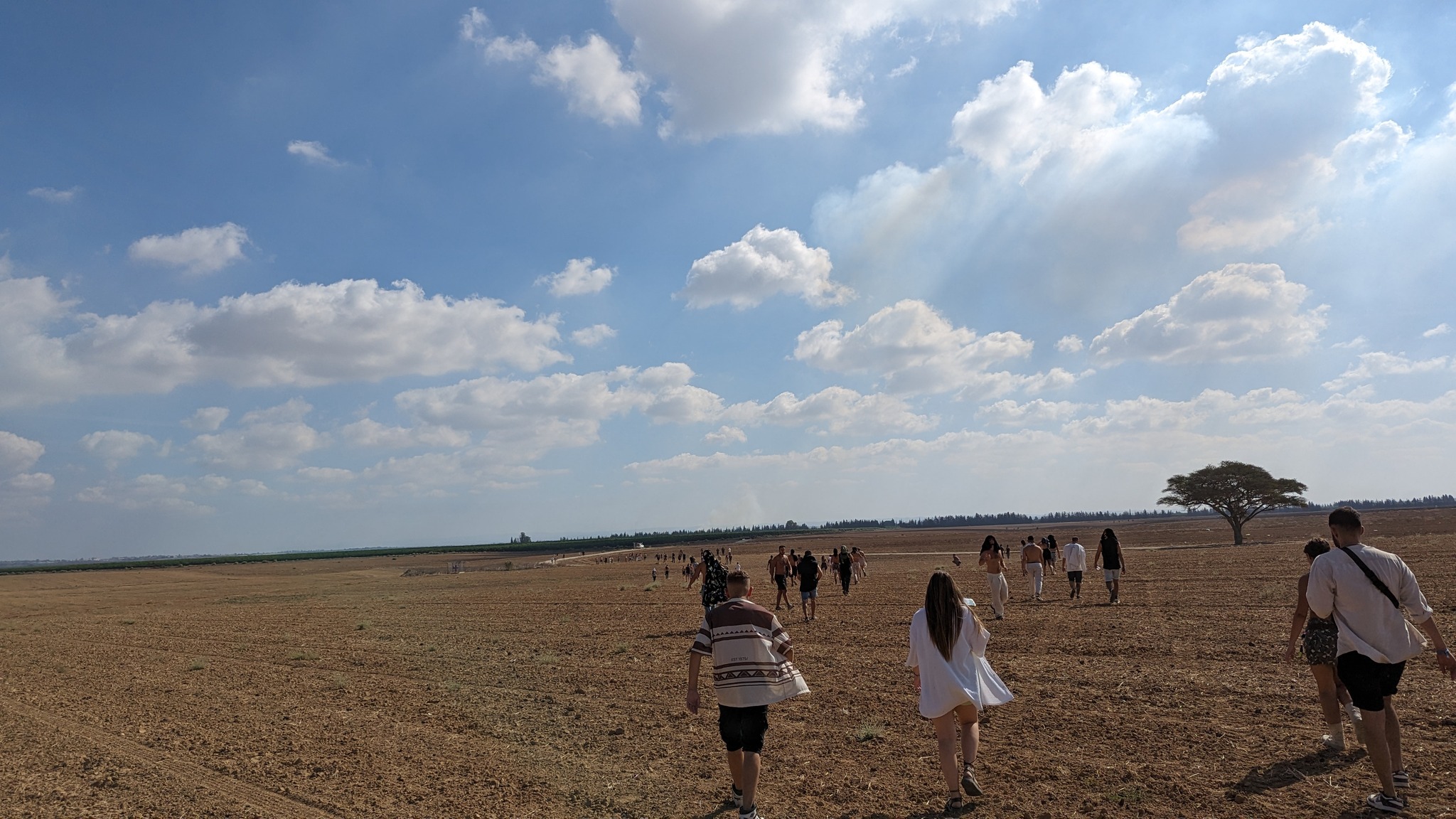 People are walking in an open field