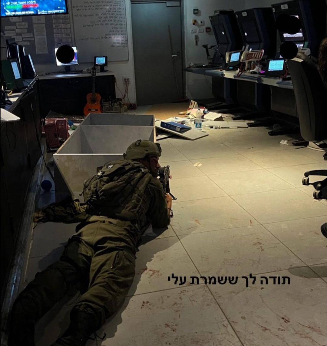 A soldier with a weapon is hiding behind a cupboard