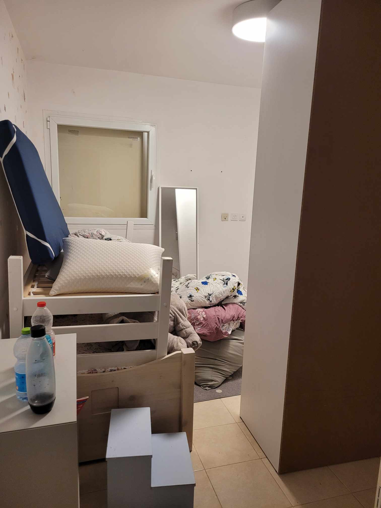 Children's bedroom with blankets on the floor