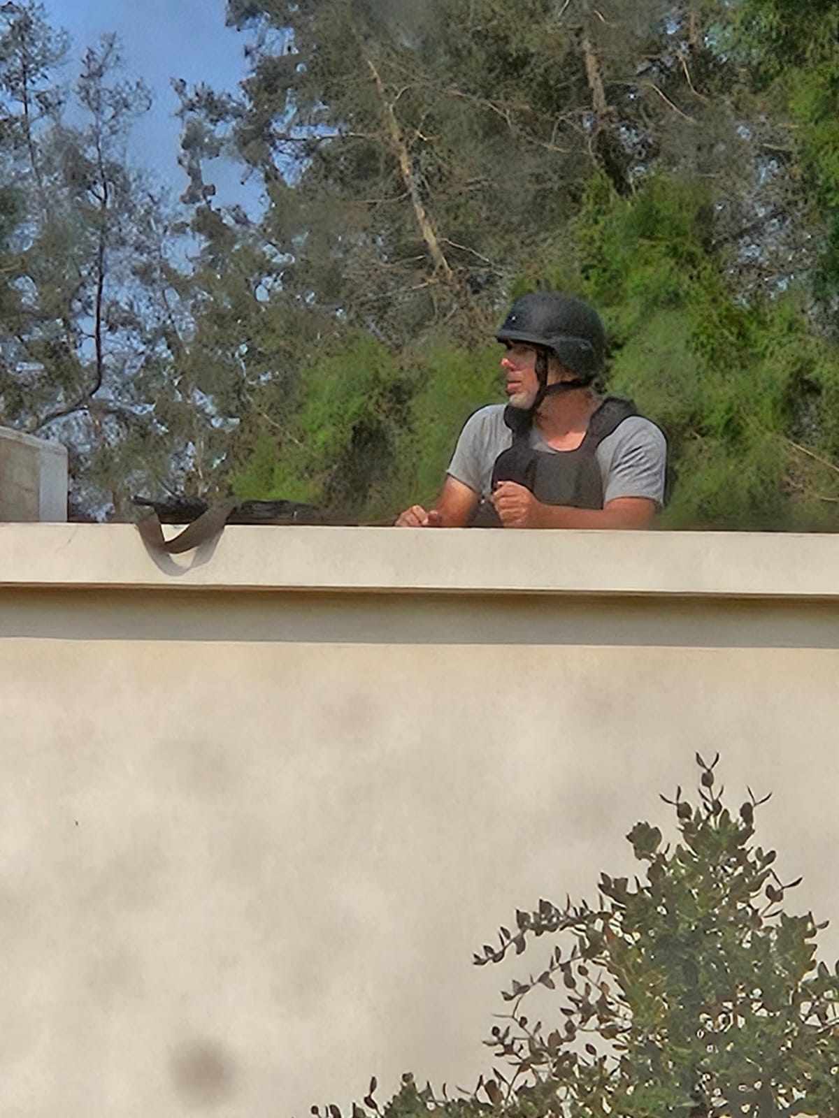 Noam G with a helmet, vest and a weapon