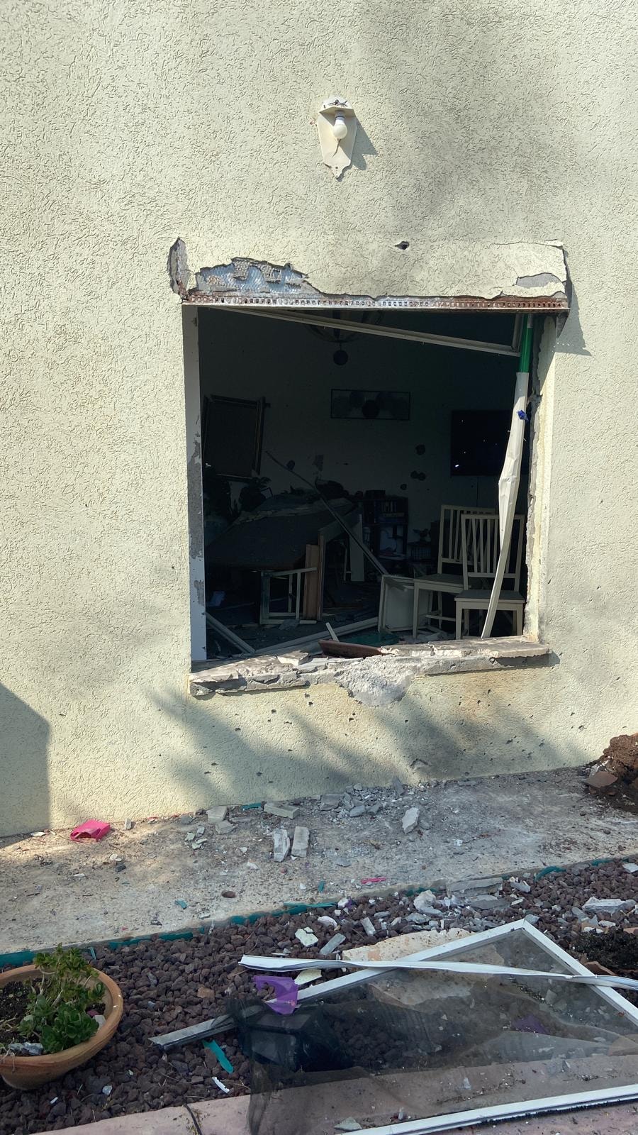 A broken window at Efrat S. sister's house
