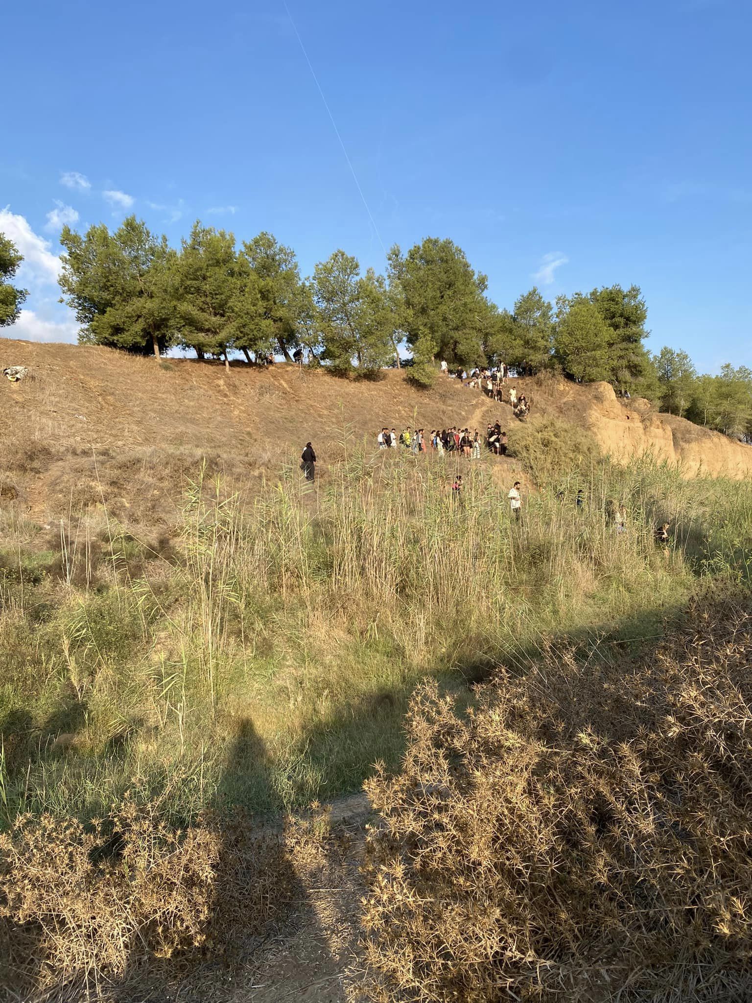 People walking on the hills of the fields