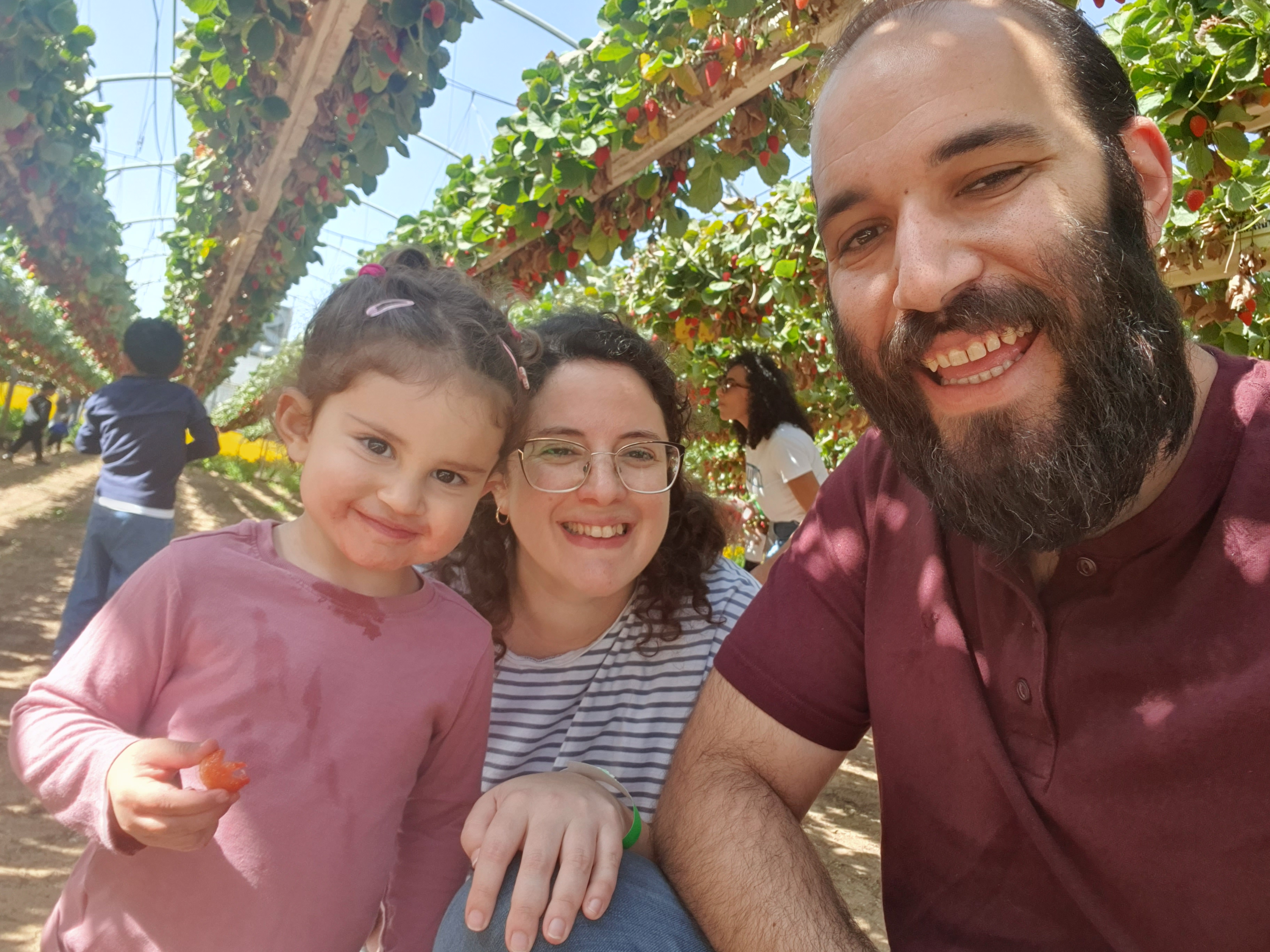 Shai S, her husband Poli and her daughter Arbel smiling
