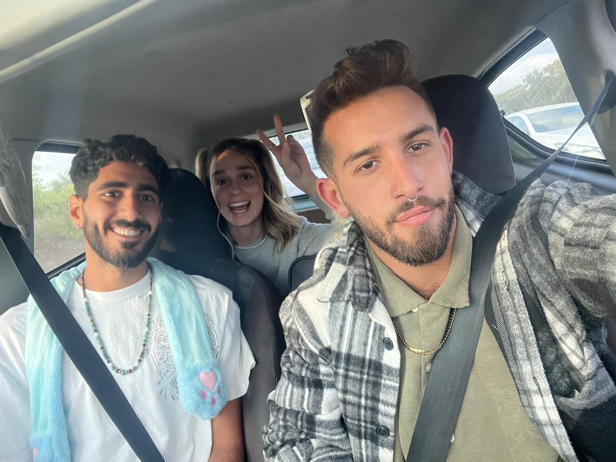 Eyal G. in the car with his friends smiling
