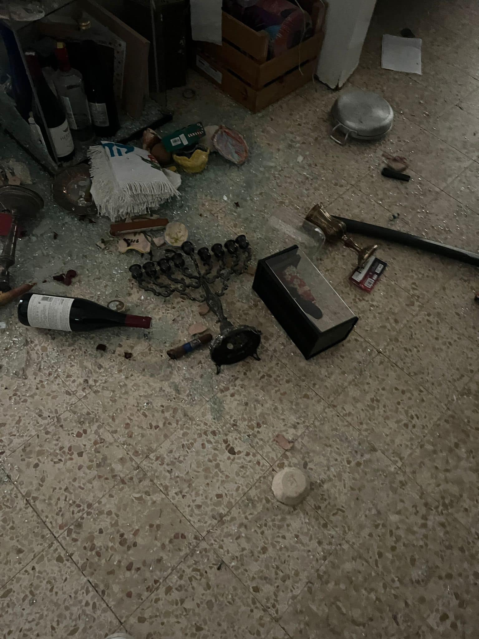 Menorah, mezuzah and other things thrown on the floor